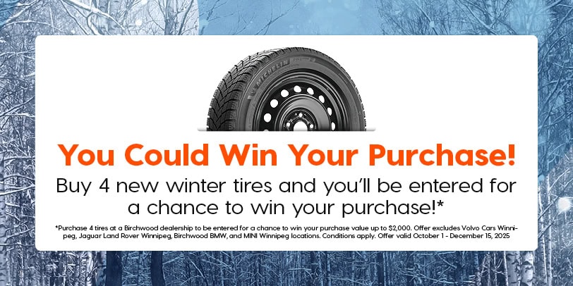 Promotional banner with a winter forest background and an image of a Michelin winter tire. Text reads, “You Could Win Your Purchase! Buy 4 new winter tires and you’ll be entered for a chance to win your purchase!*” Fine print below explains that the offer is valid at select Birchwood dealerships from October 1 to December 15, 2025, with a maximum prize value of $2,000.