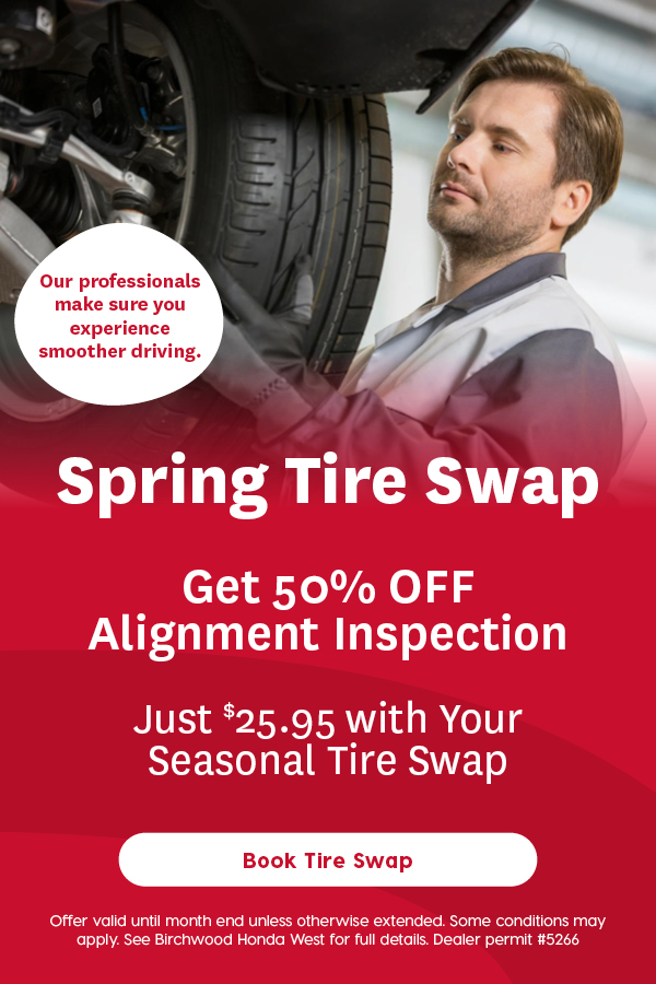 Automotive service promotion featuring a mechanic inspecting a vehicle tire with headline “Spring Tire Swap.” Offer includes 50% off an alignment inspection for $25.95 with a seasonal tire swap and a “Book Tire Swap” call to action.